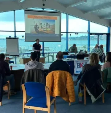UK stand up paddle instructors sat around a table at the BSUPA school and instructor conference